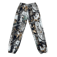 a pair of camouflage sweatpants on a black background
